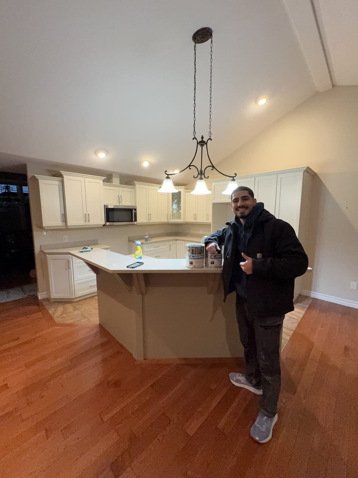Cream cabinet finish Owner in a completed cream kitchen cabinet painting project