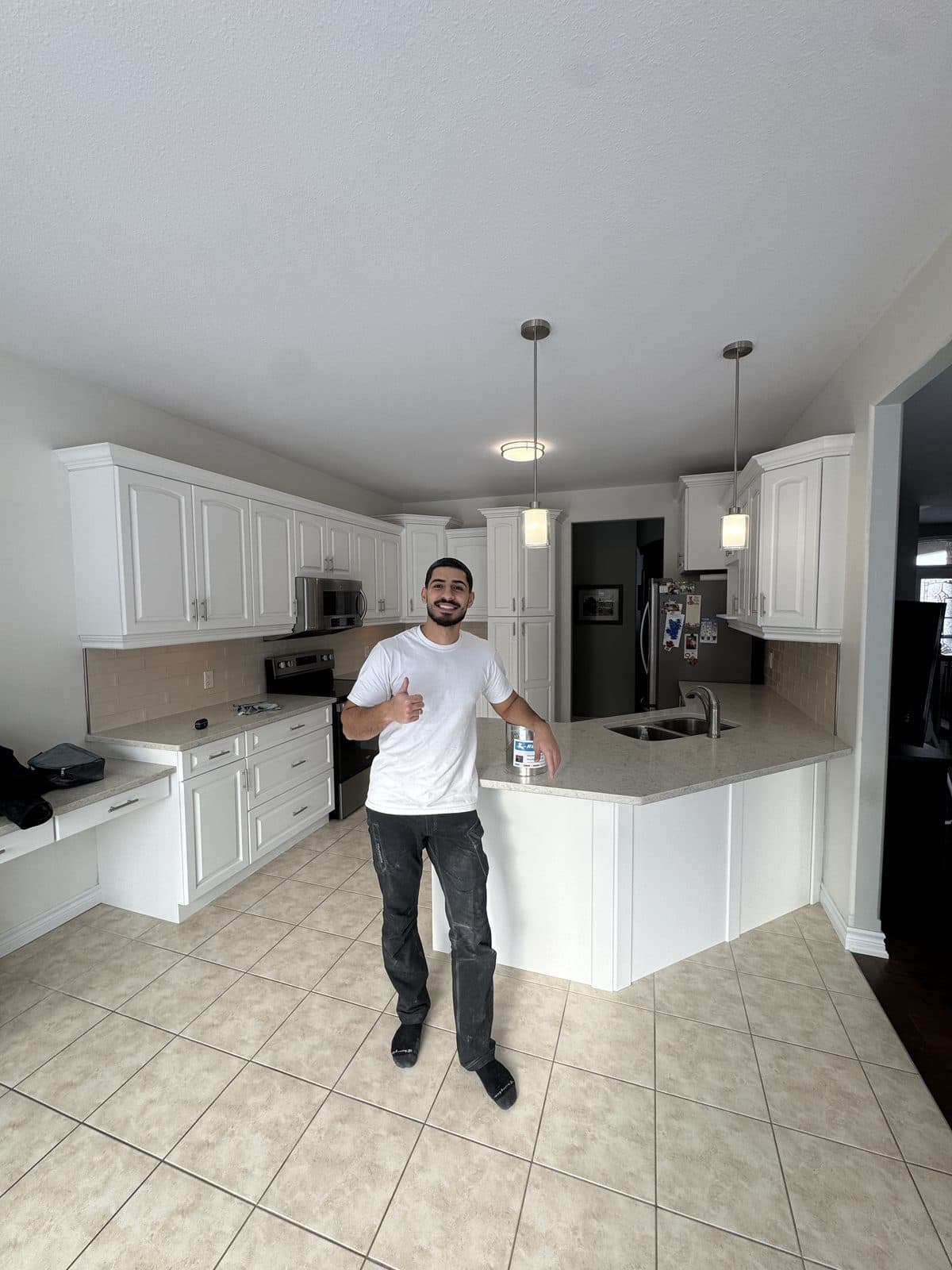 Finished white kitchen cabinet painting Primal Cabinet Painting owner in a completed white kitchen cabinet refinishing project