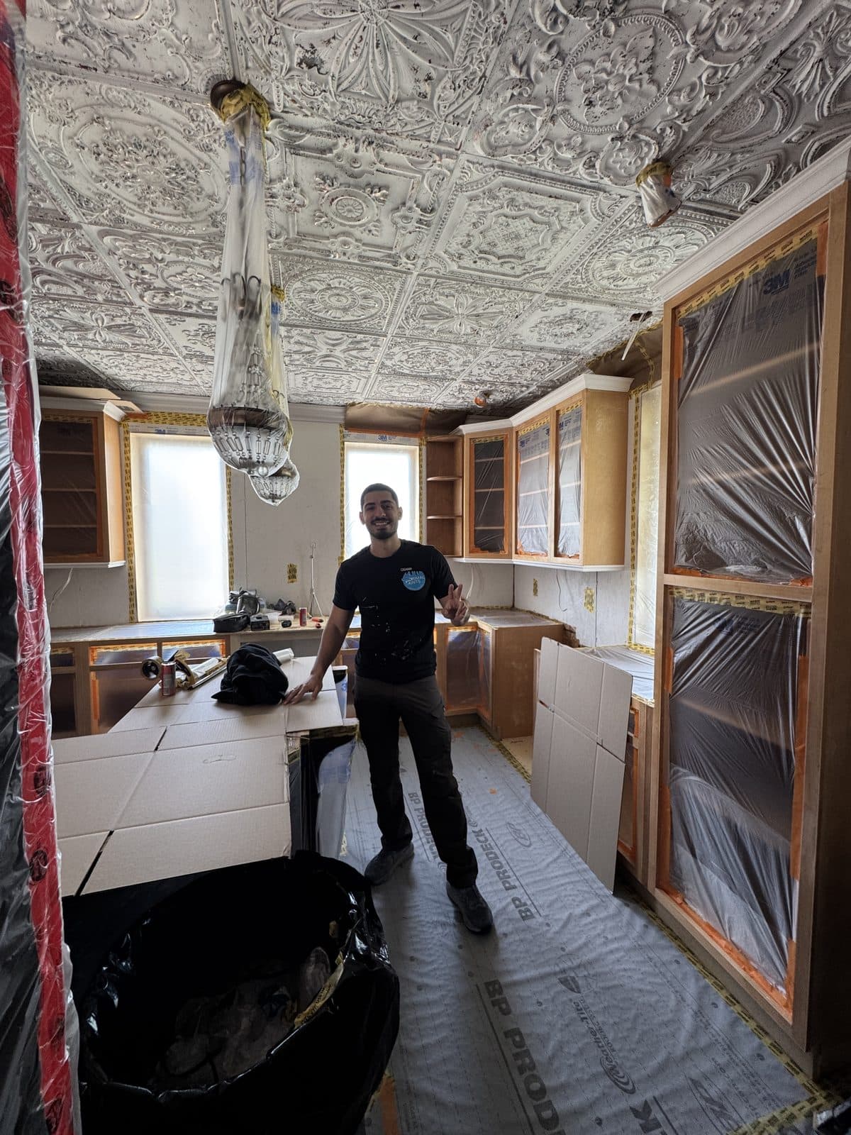 Historic kitchen cabinet refinish prep Historic kitchen cabinet refinishing preparation with protected floors and masked doors