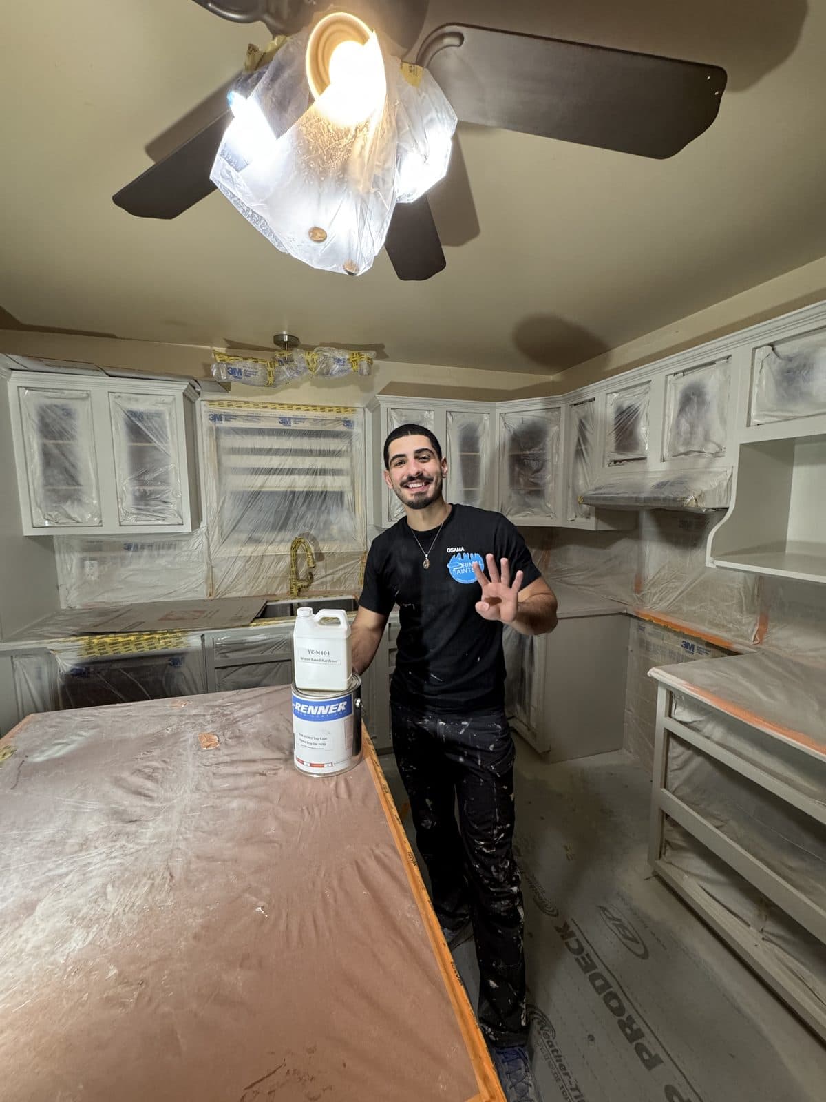 Masked white cabinet primer prep White cabinet primer preparation with masked kitchen surfaces