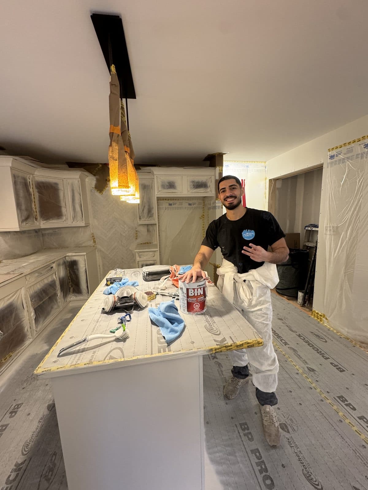 White cabinet BIN primer setup Masked white cabinet kitchen with BIN primer and protected surfaces