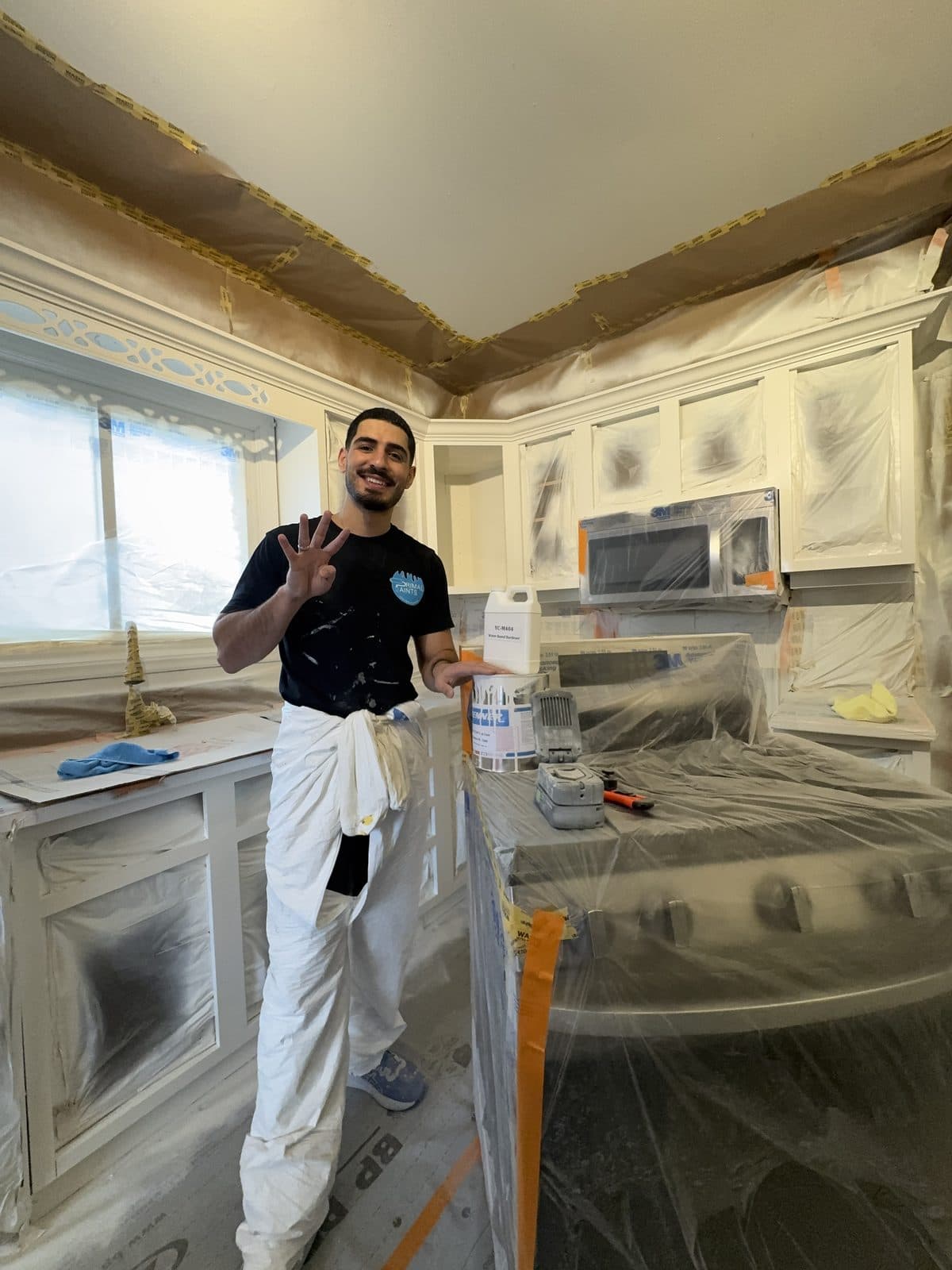 White cabinets masked for primer White kitchen cabinets masked for primer and spray coats